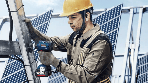 BOSCH GDS 18V-400 Cordless Impact Wrench Professional in Use: Worker Installing Solar Panels