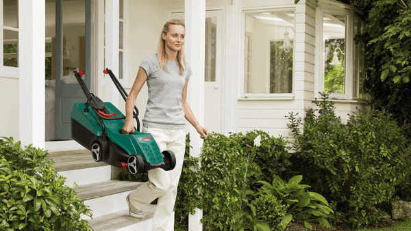 Bosch Rotak 32 Electric Lawnmower - Lightweight & Portable - Woman Carrying