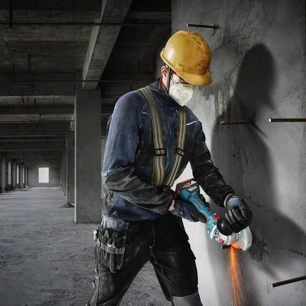 Bosch GWS 180-LI Cordless Angle Grinder: Man cutting metal. Professional power tool for construction. Sparks flying.