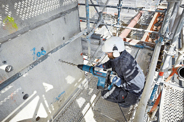 BOSCH ROTARY HAMMER GBH 12-52 DV PROFESSIONAL - power drill drilling concrete on construction site - chavda.com