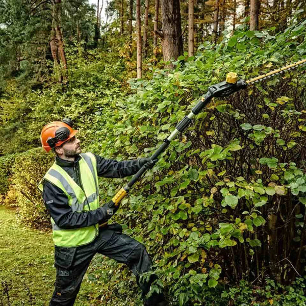 DEWALT Pole Hedge Trimmer in Action: Cordless Garden Tool for Landscaping.