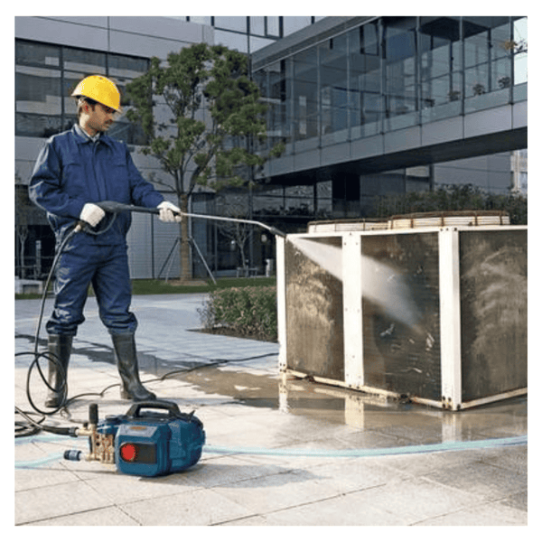 BOSCH GHP 5-13 C Pressure Washer: Professional power washing for efficient cleaning. Man using high pressure washer outdoors.