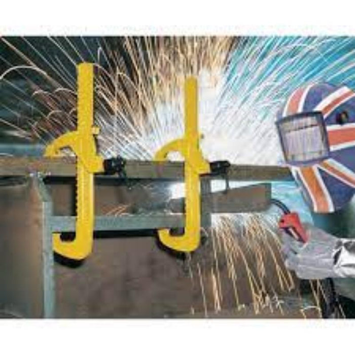 INDEXA SD750 Standard Duty Clamp in use: Welding with yellow metal clamps and sparks flying. Heavy Duty Clamping Tool for Metalworking.