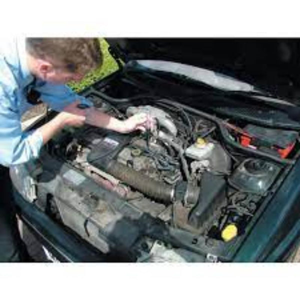 Car engine repair with circuit tester. Electrical testing in auto repair. Kennedy 6/12V tester in use.