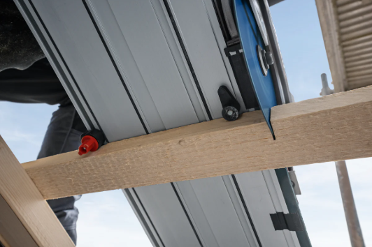 Bosch GKS 18V-57-2 GX Cordless Circular Saw cutting wood on a job site. Available at chavda.com.