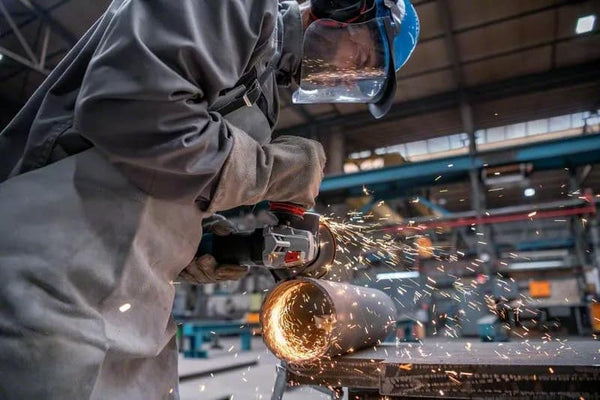 Bosch Angle Grinder Cutting Metal: Sparks Flying, Metalworking Action, and Safety Gear